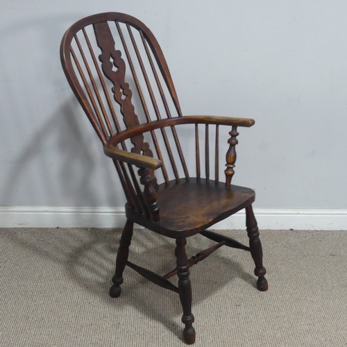 121 - A Victorian ash and elm Windsor Armchair, the pierced splat and spindle back above a moulded seat an... 
