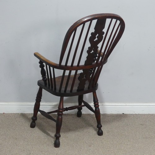 121 - A Victorian ash and elm Windsor Armchair, the pierced splat and spindle back above a moulded seat an... 