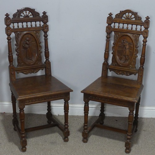 108 - A pair of late 19th century French oak hall Chairs, the heavily carved backrest upon a squared seat,... 