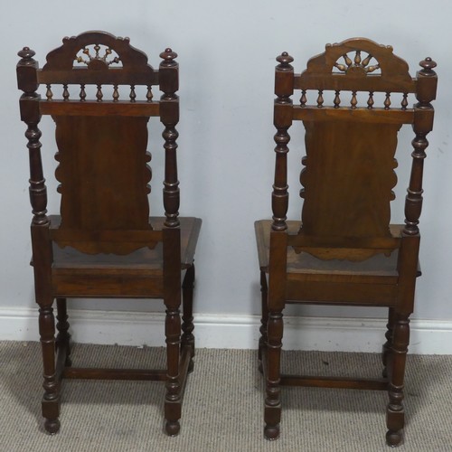 108 - A pair of late 19th century French oak hall Chairs, the heavily carved backrest upon a squared seat,... 
