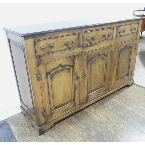 115 - A reproduction Georgian-style oak dresser Base, with brass swing handles and escutcheons, W 154 cm x... 