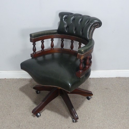189 - A 20th century Captains desk Chair, with studded green leather upholstery, the swivel base complete ... 