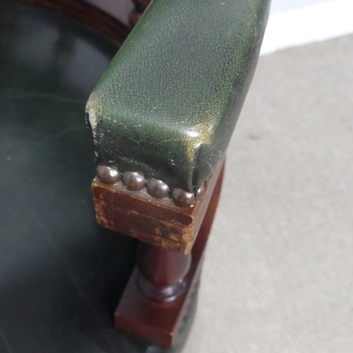 189 - A 20th century Captains desk Chair, with studded green leather upholstery, the swivel base complete ... 