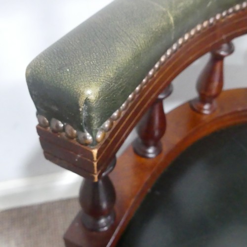 189 - A 20th century Captains desk Chair, with studded green leather upholstery, the swivel base complete ... 