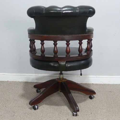 189 - A 20th century Captains desk Chair, with studded green leather upholstery, the swivel base complete ... 