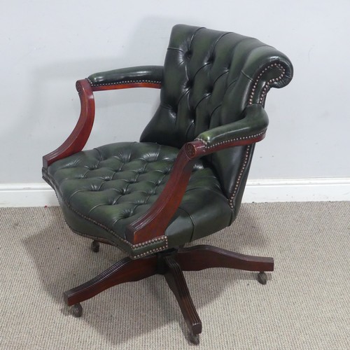 118 - A 20th century green leather captain's desk Chair, raised on a reeded swivel base and castors, W 72 ... 