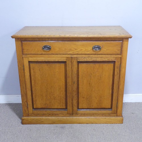 230 - A 20th century oak Cabinet, the moulded top above a singular frieze drawer, raised upon a plinth bas... 
