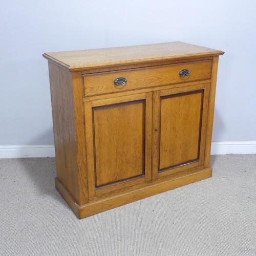 230 - A 20th century oak Cabinet, the moulded top above a singular frieze drawer, raised upon a plinth bas... 