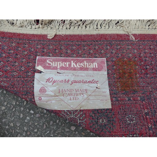 294 - A large red ground Bokhara style machine-made 'Super-Kashan' carpet, in good condition, 320cm x 200c... 