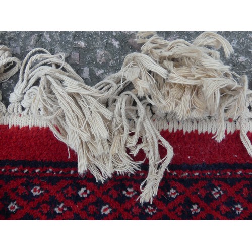 294 - A large red ground Bokhara style machine-made 'Super-Kashan' carpet, in good condition, 320cm x 200c... 