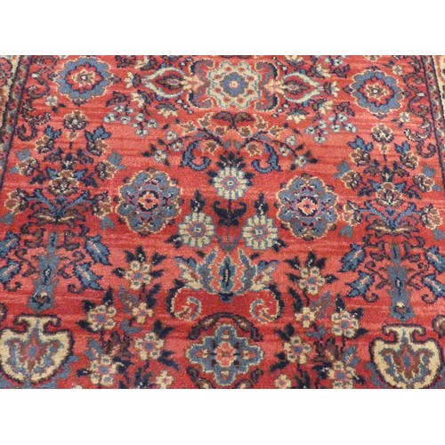 296 - A red ground Qashqai style machine-made 'Mossoul' rug, in good condition, 185cm x 85cm,... 