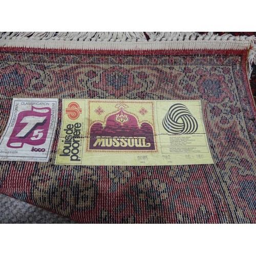 296 - A red ground Qashqai style machine-made 'Mossoul' rug, in good condition, 185cm x 85cm,... 