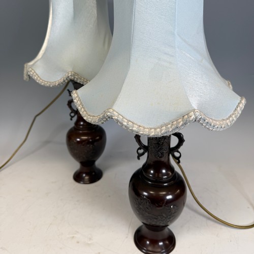 202 - A pair of Japanese-style bronzed table Lamps, of a vase form, decorated with foliate motifs, stylise... 