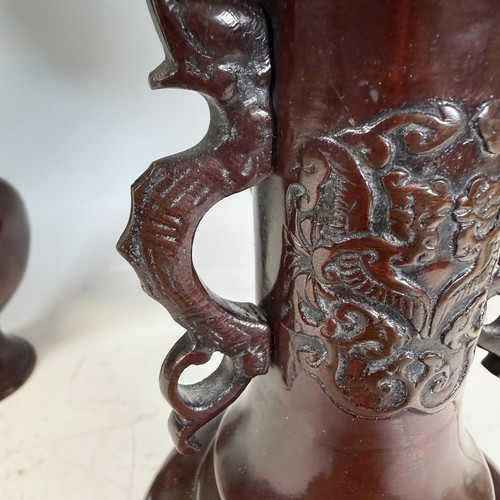 202 - A pair of Japanese-style bronzed table Lamps, of a vase form, decorated with foliate motifs, stylise... 
