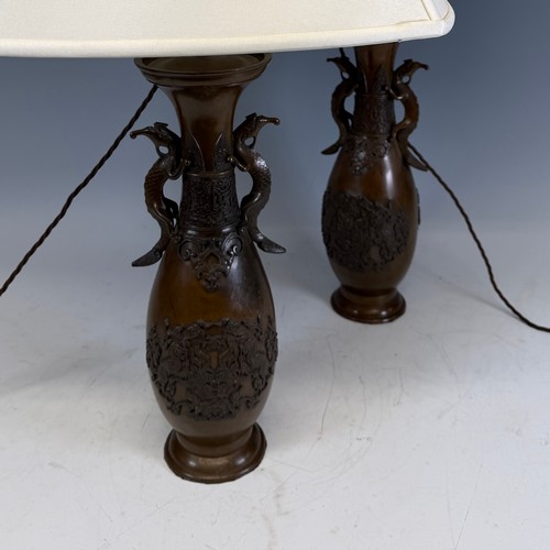 203 - A pair of Japanese-style bronzed table Lamps, of a vase form, with stylised dragon handles, and whit... 