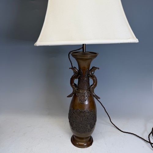 203 - A pair of Japanese-style bronzed table Lamps, of a vase form, with stylised dragon handles, and whit... 