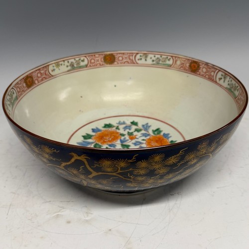 216 - A 19th century blue and gilt porcelain Bowl, decorated with floral motifs, H 13 cm x diameter 31.5 c... 