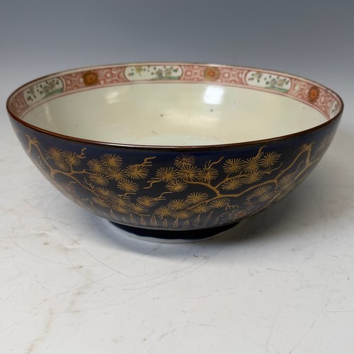 216 - A 19th century blue and gilt porcelain Bowl, decorated with floral motifs, H 13 cm x diameter 31.5 c... 