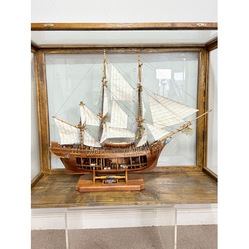 165 - A scratch-built model of the H.M.S Bounty, built by H.J Brabham, 2000, housed in an oak glazed Case,... 