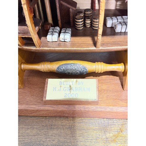 165 - A scratch-built model of the H.M.S Bounty, built by H.J Brabham, 2000, housed in an oak glazed Case,... 