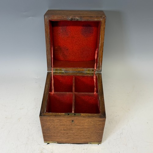 102 - A Victorian oak brass bound Tantalus, with fitted red baize interior, and inset brass swing handles,... 