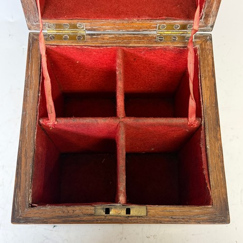 102 - A Victorian oak brass bound Tantalus, with fitted red baize interior, and inset brass swing handles,... 