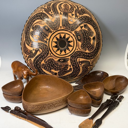 285 - African Artefacts; a carved wooden seven piece serving set, comprising a large triangular salad bowl... 
