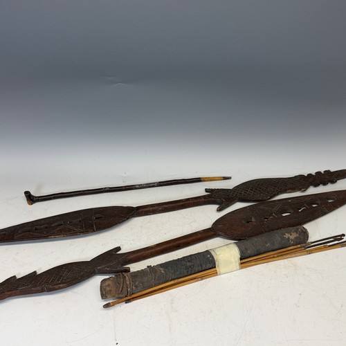 286 - Tribal Artefacts; a pair of carved wooden spears/paddles, some losses to carving, together with a qu... 