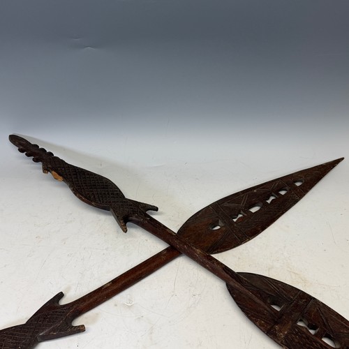 286 - Tribal Artefacts; a pair of carved wooden spears/paddles, some losses to carving, together with a qu... 