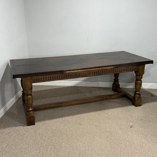 116 - A 17th century style oak extending refectory dining Table, the turned supports united by a 'H' stret... 