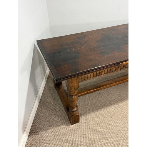 116 - A 17th century style oak extending refectory dining Table, the turned supports united by a 'H' stret... 