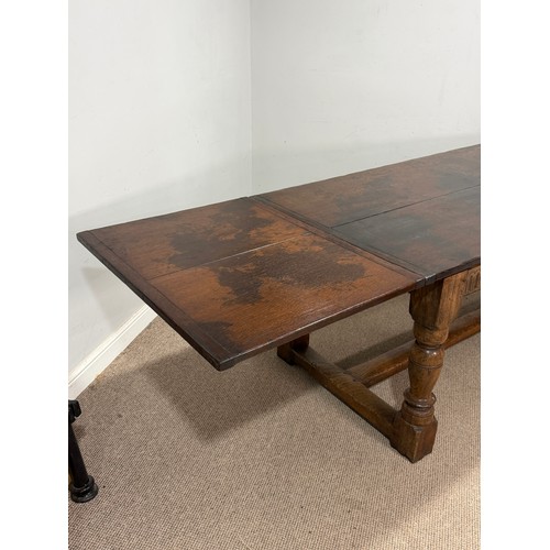 116 - A 17th century style oak extending refectory dining Table, the turned supports united by a 'H' stret... 