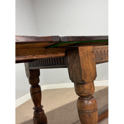116 - A 17th century style oak extending refectory dining Table, the turned supports united by a 'H' stret... 