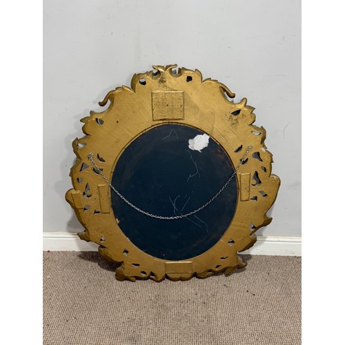 224 - A Louis XVI style gilt painted wall Mirror, the oval bevelled mirror plate in a profusely decorated ... 