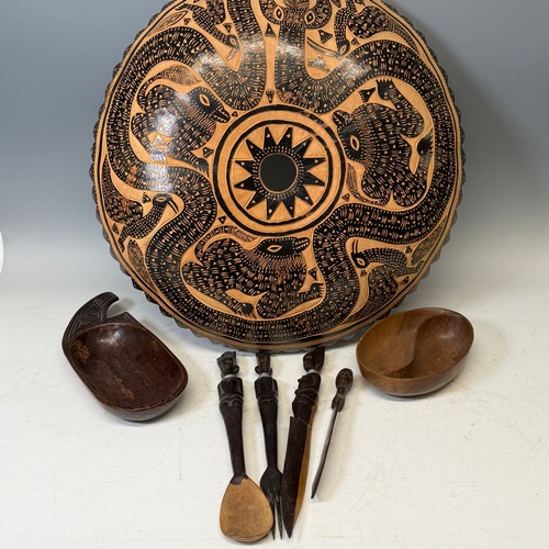 285 - African Artefacts; a carved wooden seven piece serving set, comprising a large triangular salad bowl... 
