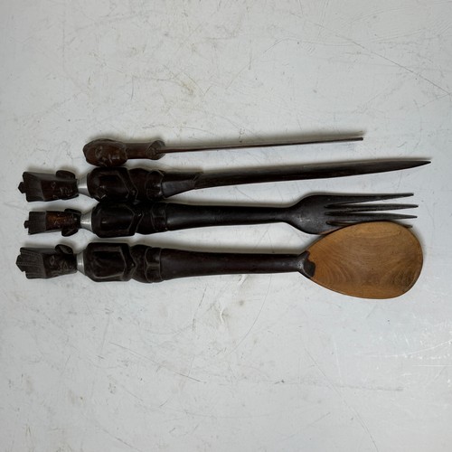 285 - African Artefacts; a carved wooden seven piece serving set, comprising a large triangular salad bowl... 