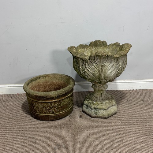 179 - A weathered reconstituted stone garden Urn, with acanthus/cabbage leaf bowl, raised on an octagonal ... 
