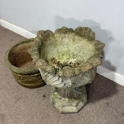 179 - A weathered reconstituted stone garden Urn, with acanthus/cabbage leaf bowl, raised on an octagonal ... 