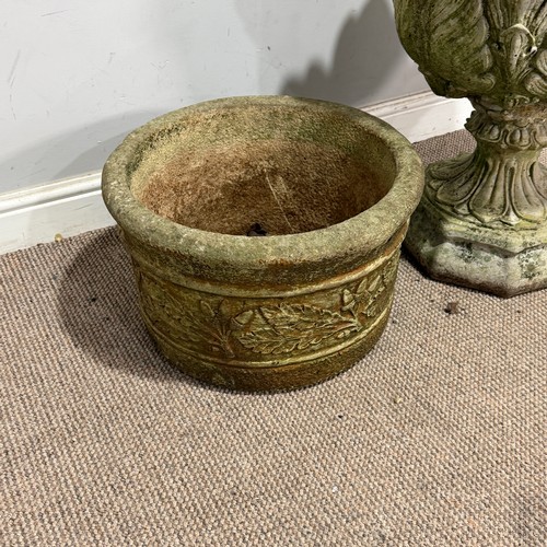 179 - A weathered reconstituted stone garden Urn, with acanthus/cabbage leaf bowl, raised on an octagonal ... 