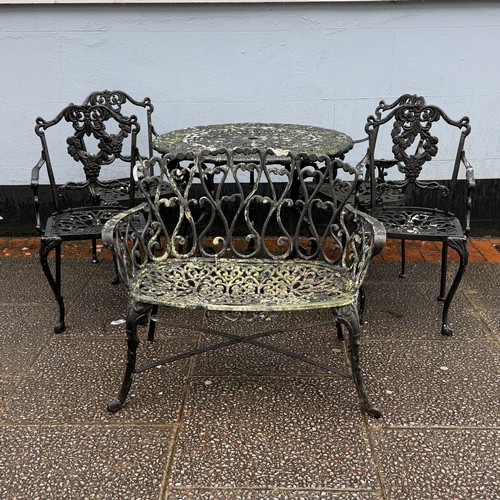 173 - A cast and painted circular garden Table, decorated with stylised leaves and scrolls, the under-tier... 