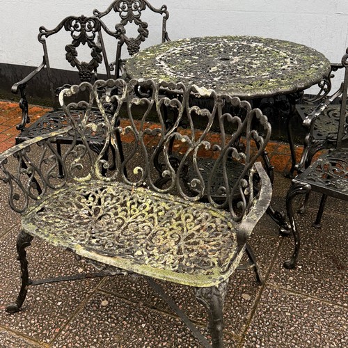 173 - A cast and painted circular garden Table, decorated with stylised leaves and scrolls, the under-tier... 