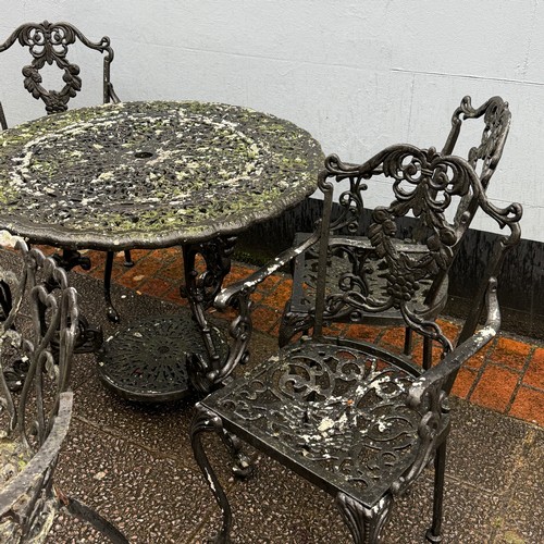 173 - A cast and painted circular garden Table, decorated with stylised leaves and scrolls, the under-tier... 