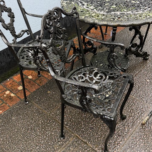 173 - A cast and painted circular garden Table, decorated with stylised leaves and scrolls, the under-tier... 