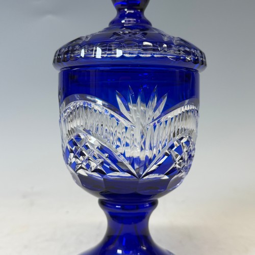 186 - A Bavarian blue flashed and cut glass Vase and Cover, of goblet form, H 27.5 cm, together with two d... 