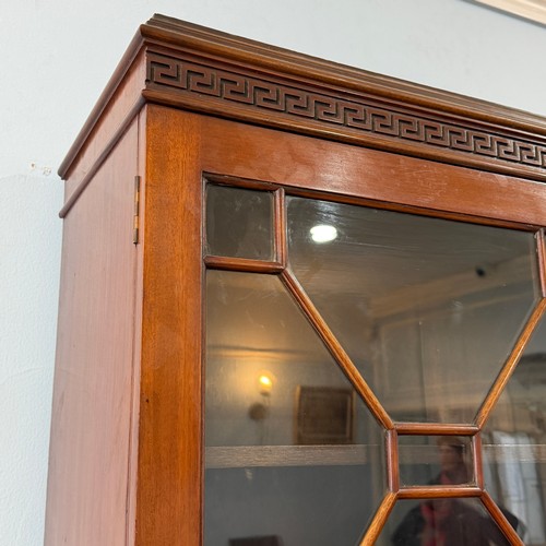 253 - A 20th century Chinese hardwood display Cabinet/Bookcase, the moulded cornice above astragal glazed ... 