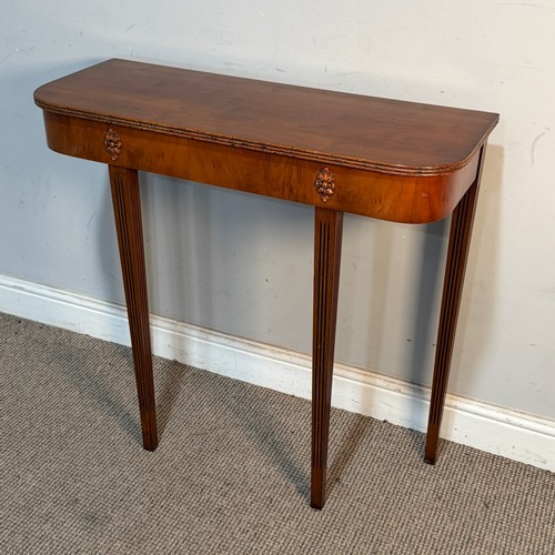 A reproduction yew console Table, raised upon reeded tapering supports ...