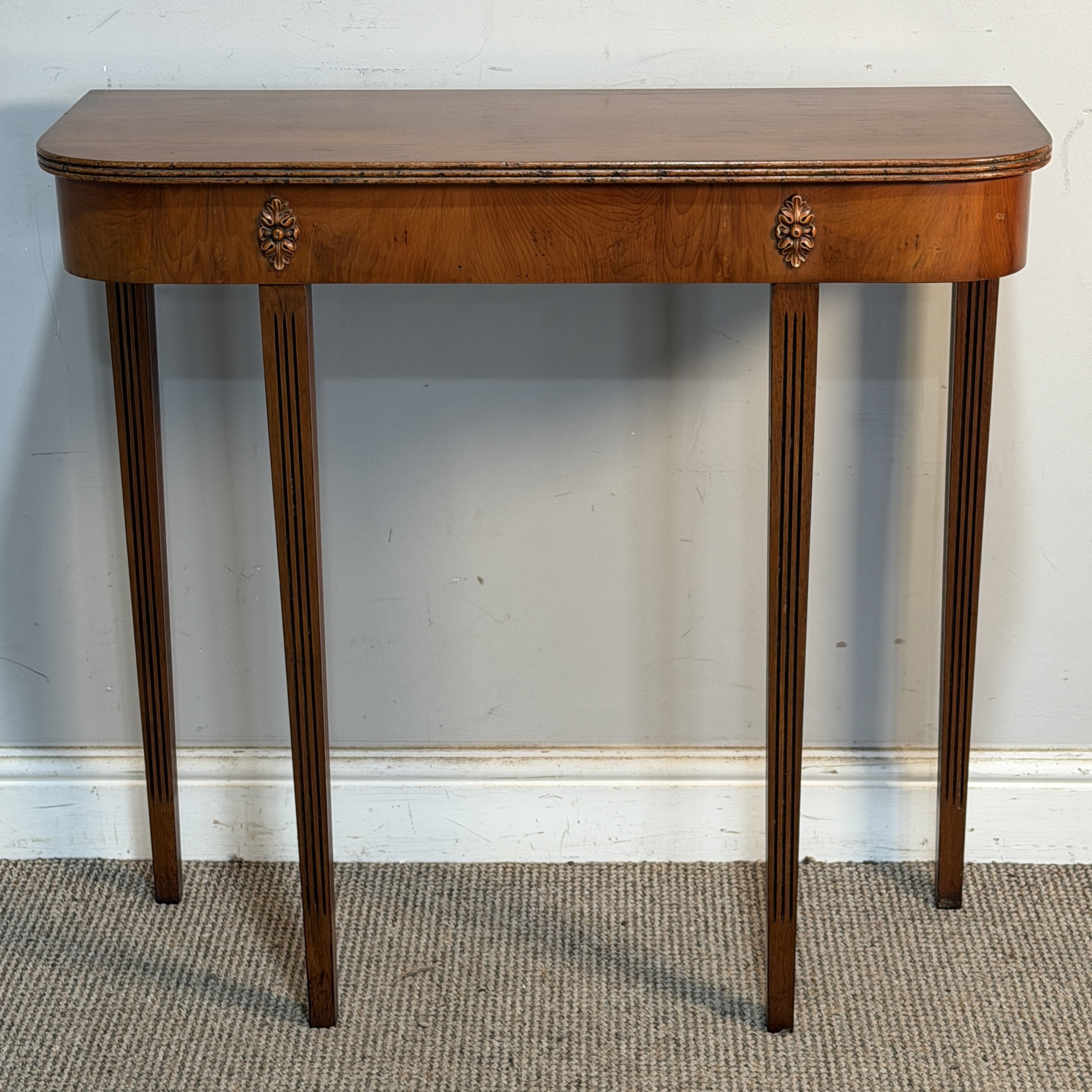 A reproduction yew console Table, raised upon reeded tapering supports ...