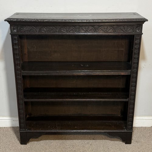 64 - An antique Victorian style carved oak open Bookcase, raised upon short tapering supports, W 107 cm x... 