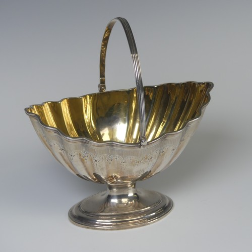 5 - A George III silver swing handled Sugar Basket, later hallmarked London 1946, gilt interior, 16.5cm ... 