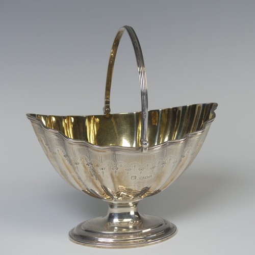 5 - A George III silver swing handled Sugar Basket, later hallmarked London 1946, gilt interior, 16.5cm ... 